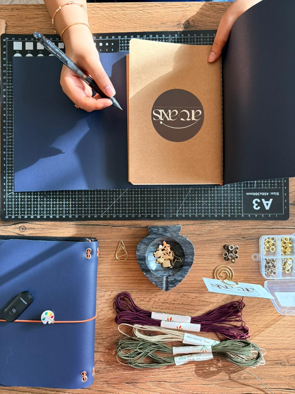 Kraft gift box with Arc and Axis brand seal — corporate journal gifts UAE
