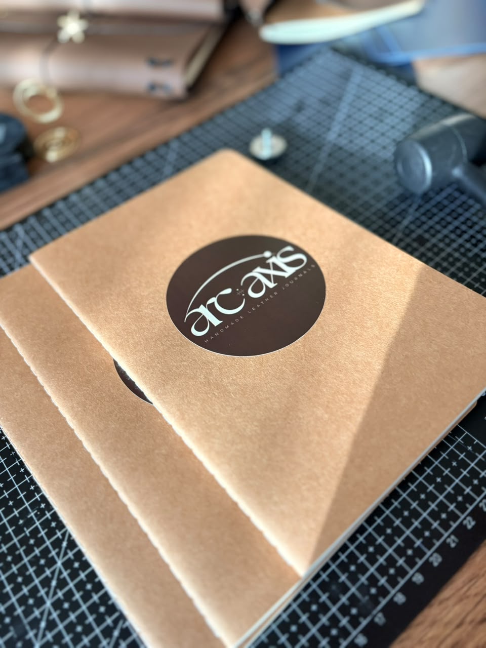 Close-up of faux leather journal cover with brand emblem — Arc and Axis
