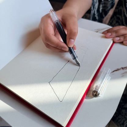 Slim Arc and Axis fountain pen writing on journal paper
