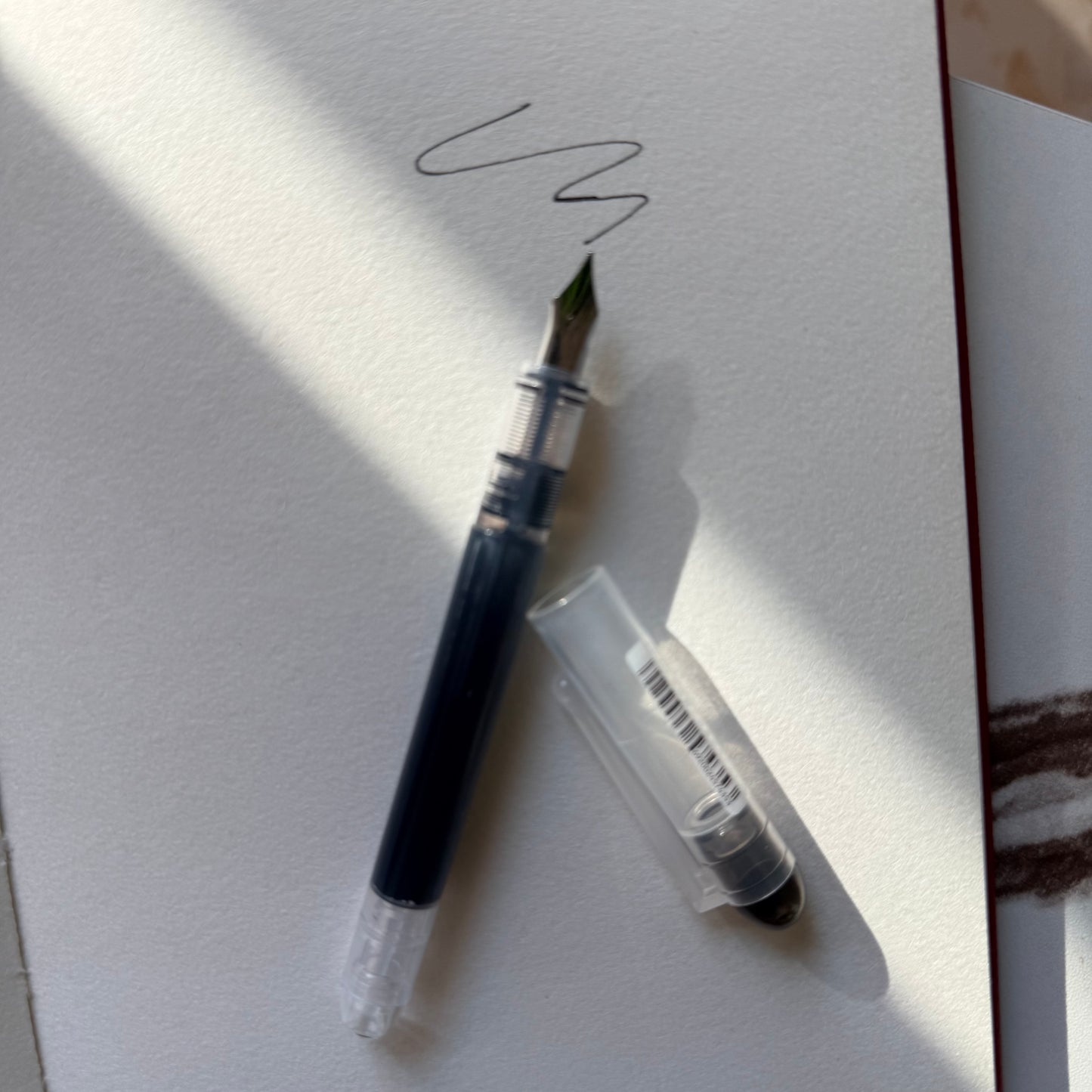 Arc and Axis fountain pen held in a journal elastic pen holder