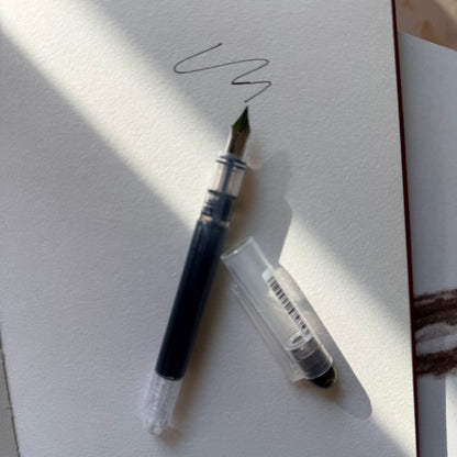 Arc and Axis fountain pen held in a journal elastic pen holder
