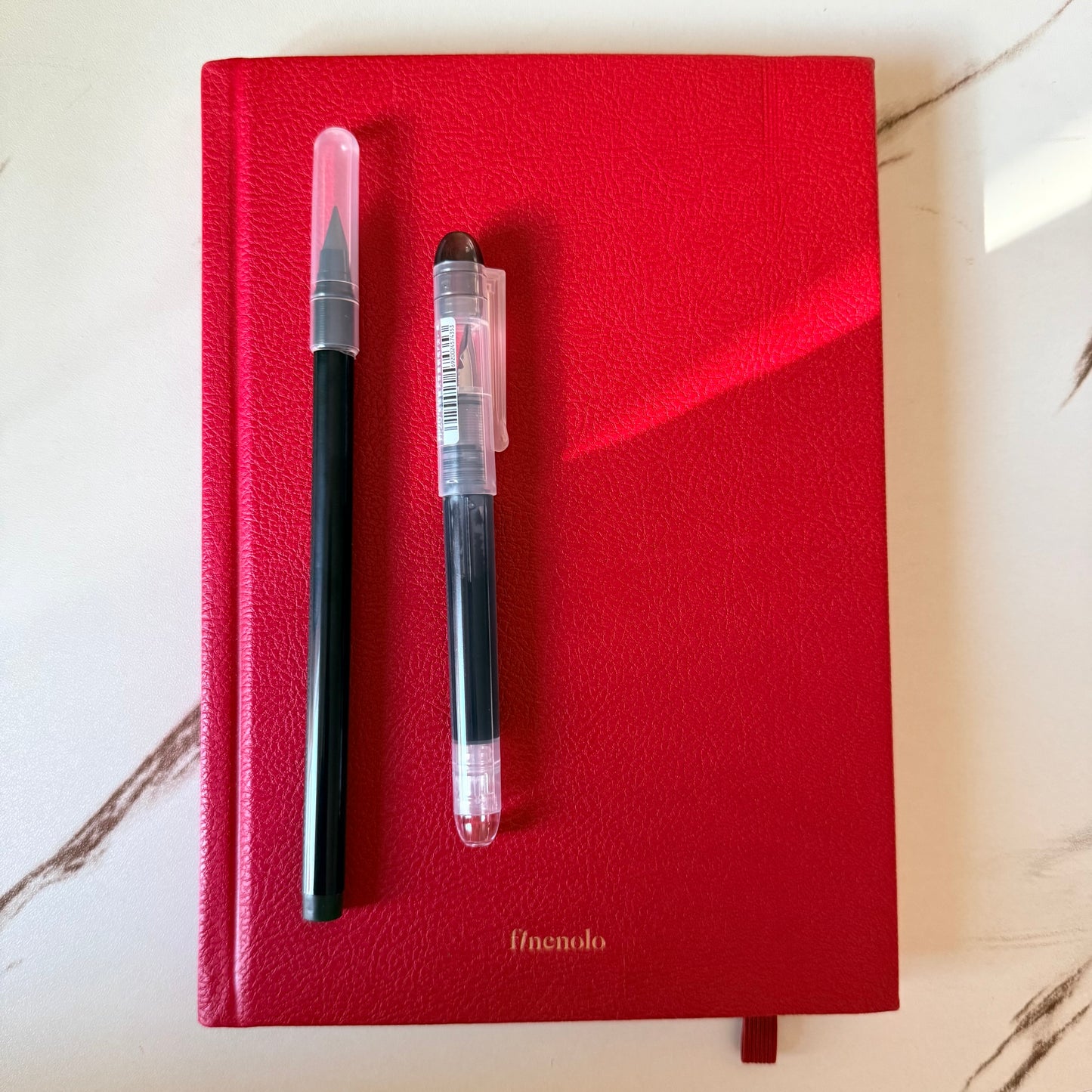 Arc and Axis Infinity Pencil writing a grey line on journal paper