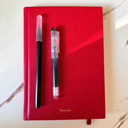 Arc and Axis Infinity Pencil writing a grey line on journal paper